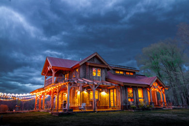 Mid-sized mountain style brown two-story wood house exterior photo in Albuquerque with a hip roof and a metal roof