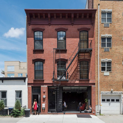 Mid-sized traditional three-story brick flat roof idea in New York
