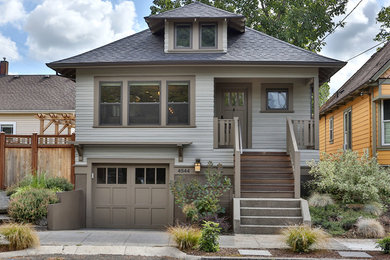 Arts and crafts gray two-story house exterior photo in Portland with a hip roof and a shingle roof