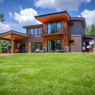 Mid-sized industrial brown two-story wood house exterior idea in Chicago with a shed roof and a metal roof
