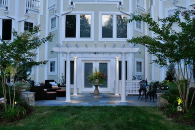 Large traditional beige three-story exterior home idea in DC Metro