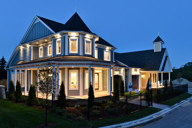 Inspiration for a timeless blue two-story wood gable roof remodel in Toronto