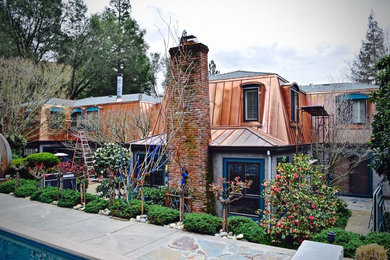 Inspiration for a large rustic multicolored two-story mixed siding house exterior remodel in San Francisco with a clipped gable roof and a metal roof