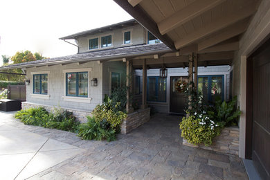 This is an example of an expansive and gey traditional two floor detached house in Los Angeles with wood cladding, a hip roof and a shingle roof.