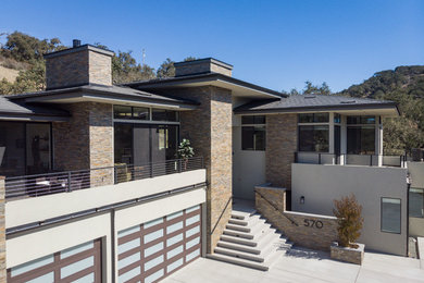 Inspiration for a mid-sized contemporary gray two-story stucco house exterior remodel in San Luis Obispo with a hip roof and a shingle roof