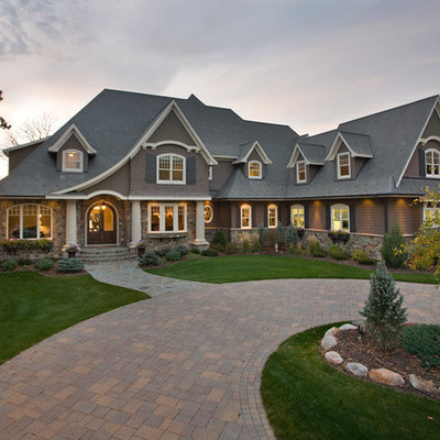 Example of a large ornate brown two-story mixed siding house exterior design in Minneapolis with a shingle roof