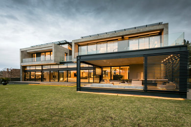 Idéer för ett modernt grått hus, med två våningar och platt tak