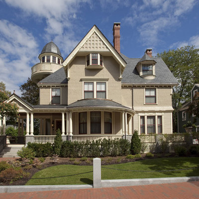 Example of a large ornate three-story wood gable roof design in Boston