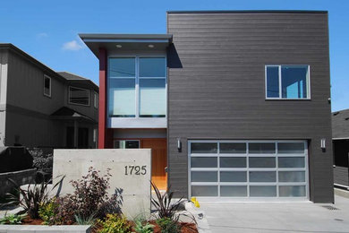 Example of a mid-sized trendy black two-story wood exterior home design in Seattle