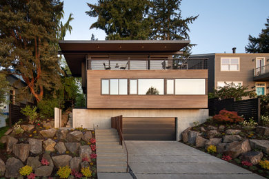 Inspiration for a contemporary three-story wood exterior home remodel in Seattle with a tile roof and a black roof