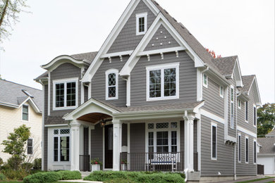 Inspiration for a large timeless gray two-story concrete fiberboard exterior home remodel in Chicago with a shingle roof