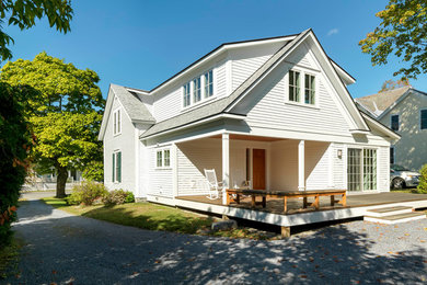 Inspiration for a mid-sized timeless white two-story wood house exterior remodel in Burlington with a shingle roof