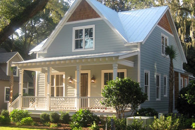 Example of a mid-sized beach style blue two-story vinyl exterior home design in Jacksonville with a metal roof