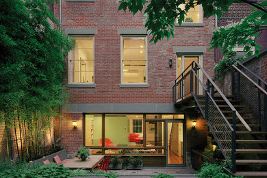 Transitional red brick exterior home idea in New York