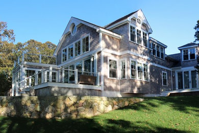 Example of a large beach style gray two-story wood exterior home design in Boston with a shingle roof