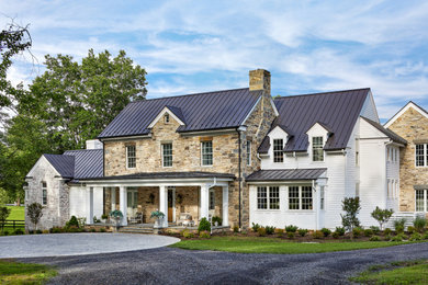 Inspiration for a french country multicolored two-story mixed siding and clapboard exterior home remodel in Other with a metal roof and a black roof