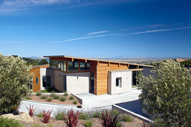 Large contemporary white one-story wood exterior home idea in San Francisco with a shed roof