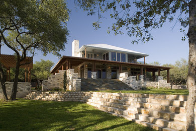 Large craftsman multicolored two-story stone house exterior idea in Austin with a clipped gable roof and a metal roof