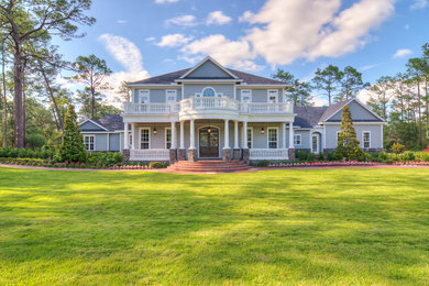 Photo of a blue and large classic two floor house exterior in Orlando with wood cladding and a pitched roof.