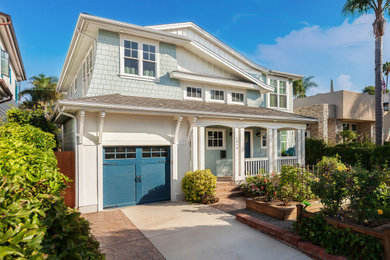 Inspiration for a large coastal multicolored two-story mixed siding house exterior remodel in San Diego with a shingle roof