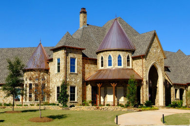 Large elegant beige two-story stone exterior home photo in Dallas