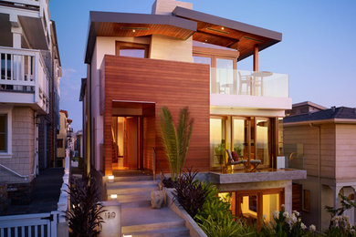 Inspiration for a mid-sized contemporary three-story wood house exterior remodel in Los Angeles with a metal roof
