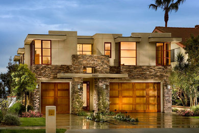Large transitional beige two-story mixed siding exterior home idea in Orange County