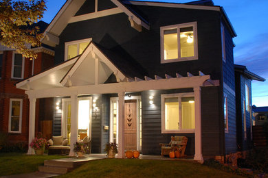 Example of a mid-sized eclectic gray two-story concrete fiberboard gable roof design in Denver