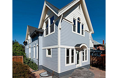 Example of a mid-sized classic blue two-story vinyl exterior home design in Denver with a hip roof