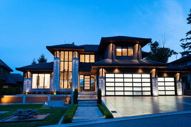 Example of a mid-sized trendy gray three-story mixed siding house exterior design in Vancouver with a clipped gable roof and a tile roof