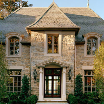 Inspiration for a timeless beige two-story stone exterior home remodel in New York