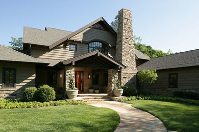 Inspiration for a large craftsman gray two-story stone gable roof remodel in Other