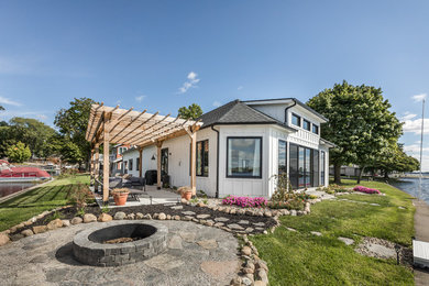 Example of a beach style white exterior home design in Indianapolis