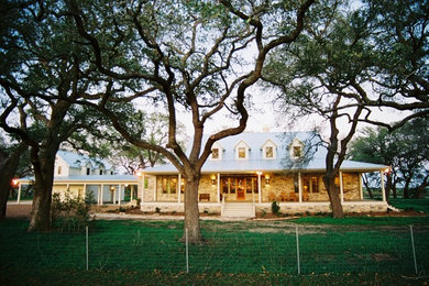 Inspiration for a large farmhouse two-story stone exterior home remodel in Houston