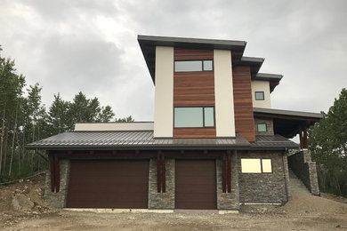 Inspiration for a large contemporary two floor detached house in Calgary with mixed cladding, a pitched roof and a metal roof.