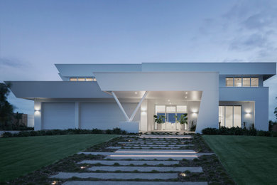 Diseño de fachada de casa blanca moderna extra grande de tres plantas con revestimiento de ladrillo, tejado plano y tejado de metal