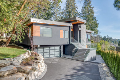 Inspiration for a modern gray two-story stucco exterior home remodel in Vancouver