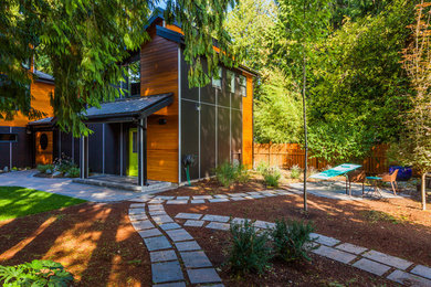 Medium sized and black contemporary two floor house exterior in Vancouver with mixed cladding.