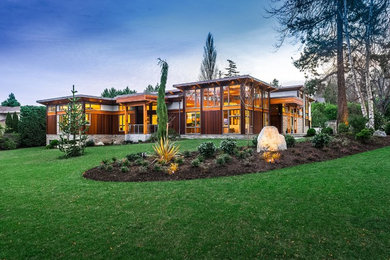 Large minimalist brown two-story wood exterior home photo in Vancouver