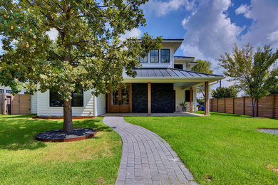 Modern white two-story concrete fiberboard exterior home idea in Austin