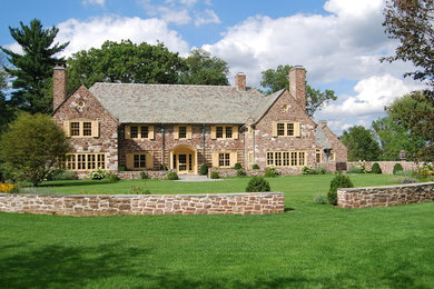 Example of a large classic two-story stone exterior home design in New York
