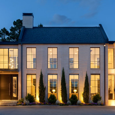 Transitional beige two-story brick gable roof photo in Little Rock