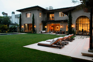 Large tuscan beige two-story stucco exterior home photo in Los Angeles