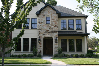 This is an example of a medium sized and beige classic two floor house exterior in Houston with mixed cladding.