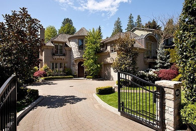Large elegant two-story stucco exterior home photo in Vancouver