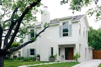 Example of a minimalist white two-story mixed siding exterior home design in Houston