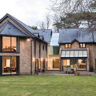 Photo of a medium sized classic two floor brick detached house in Dorset with a pitched roof and a shingle roof.