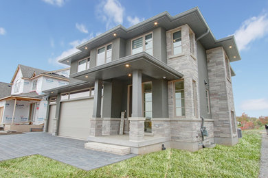 Large transitional gray two-story mixed siding exterior home photo in Toronto