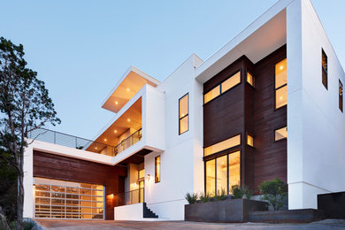 Inspiration for a large contemporary white two-story mixed siding flat roof remodel in Austin