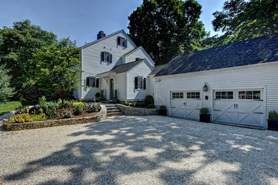 Example of a large classic white two-story vinyl exterior home design in New York with a shingle roof